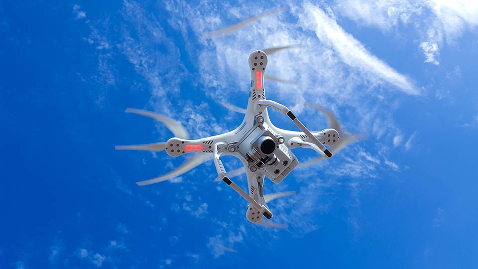 camera drone flying under blue sky